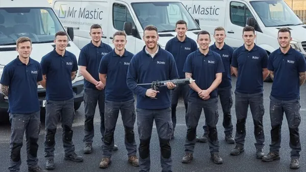 Mr Mastic applicators lined up beside the company vans, one holding a sealant gun